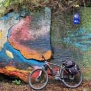 A bicycle leaning against a colourful wall on the Camino trail